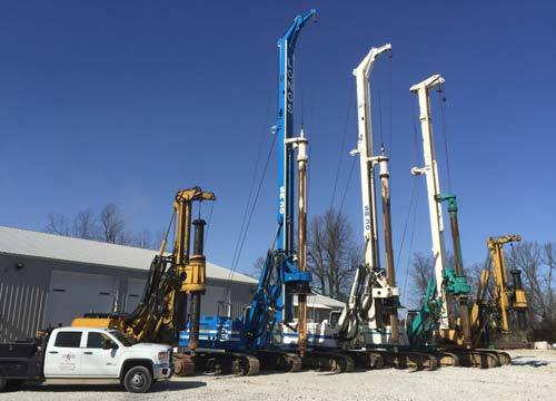 drillings rigs lined up near building