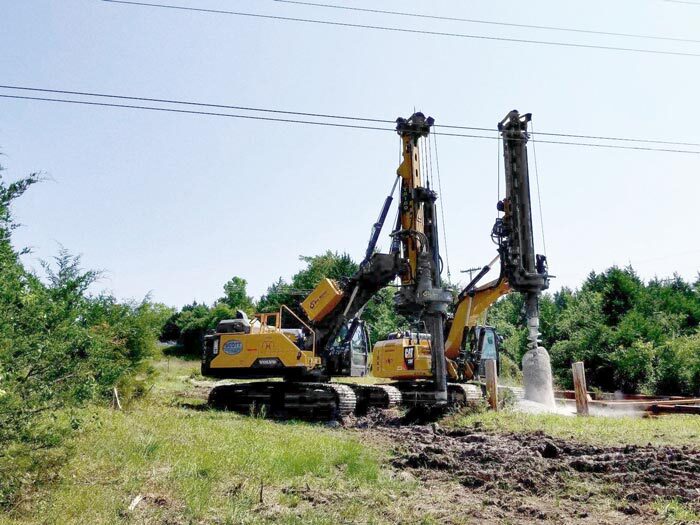 2 Large drills machines, drilling into the ground