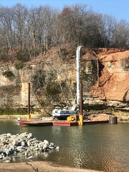 Large drill on platform near water